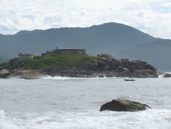 Scenic view of sea against cloudy sky