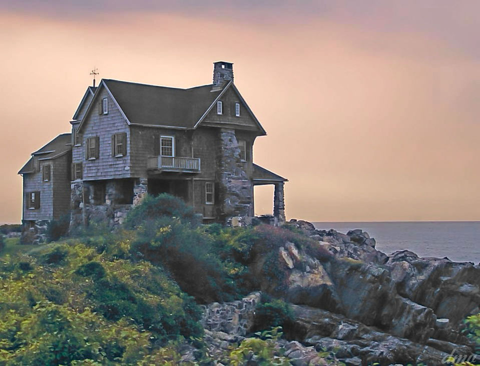 HOUSE BY SEA AGAINST SKY AT SUNSET