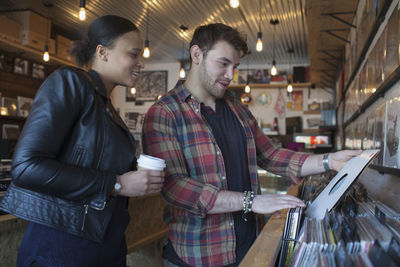 Young man and woman in a record store