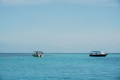 Sailboat in sea against sky