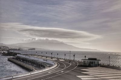 Road by sea against sky