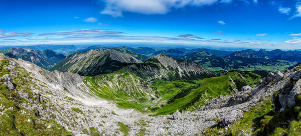 Scenic view of mountains against blue sky