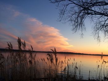 Scenic view of lake against sky during sunset