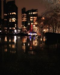 Reflection of illuminated buildings in water at night