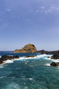 Scenic view of sea against clear blue sky