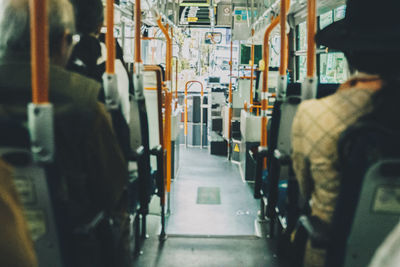 Rear view of people traveling in train