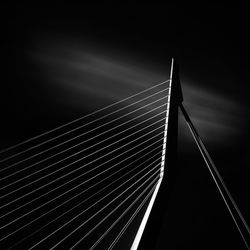Low angle view of bridge against sky at night