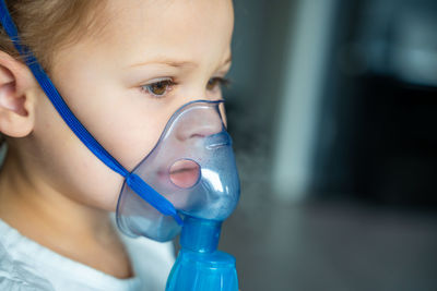 Close-up of woman wearing surgical mask