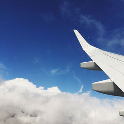 Cropped image of airplane wing against sky