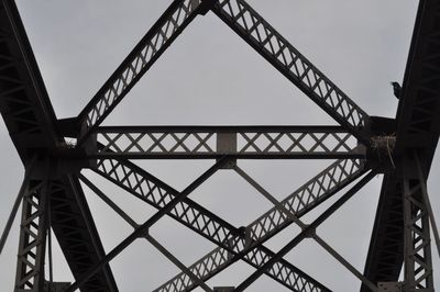 Low angle view of suspension bridge against sky