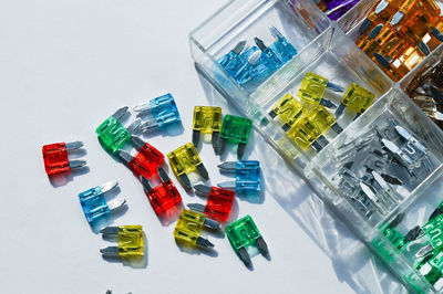 Close-up of multi colored fuse box equipment on white background