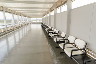 Empty chairs and tables in corridor