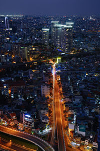 High angle view of illuminated city buildings at night