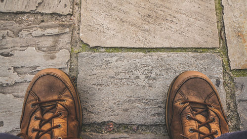 Low section of person standing on footpath