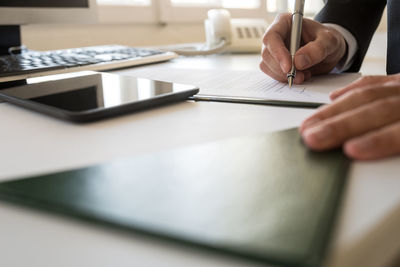 Midsection of man working on table