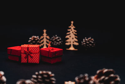 Close-up of christmas decoration on table against black background