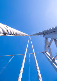 Low angle view of bridge against clear blue sky