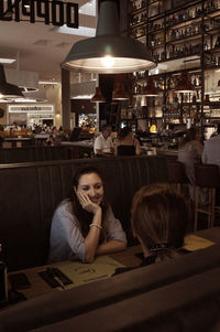 Rear view of woman sitting at restaurant