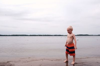 Woman standing by sea