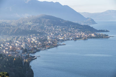 High angle view of city by sea against sky