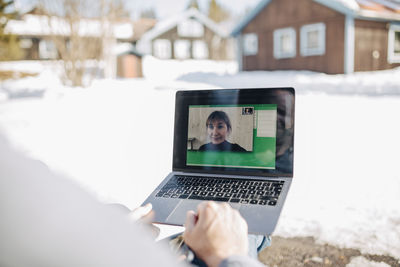 Male entrepreneur on video call through laptop with businesswoman
