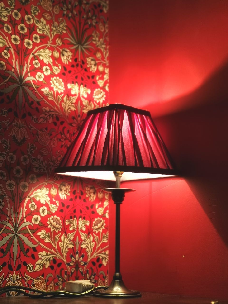 CLOSE-UP OF ILLUMINATED ELECTRIC LAMP AGAINST WALL