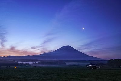 Scenic view of snowcapped mountains against sky at night