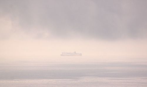 Boat sailing on sea in foggy weather
