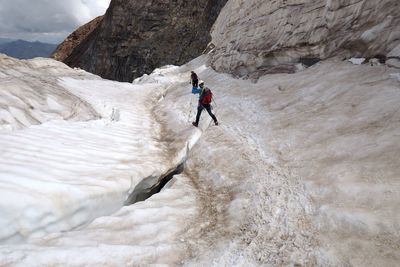 Full length of man surfing on rock in mountains