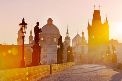 View of charles bridge with church during sunrise