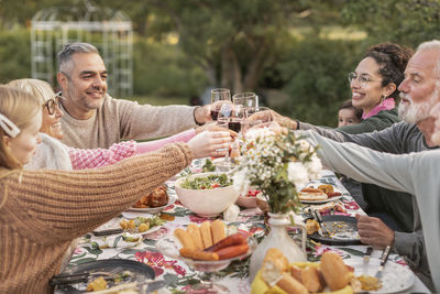 Family toasting during meal in garden