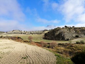 Scenic view of farm against sky