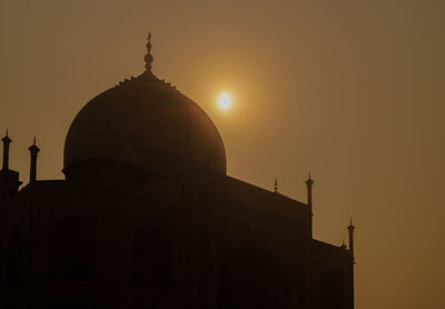 Silhouette cathedral against sky during sunset