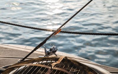 High angle view of fishing rod in boat against sea