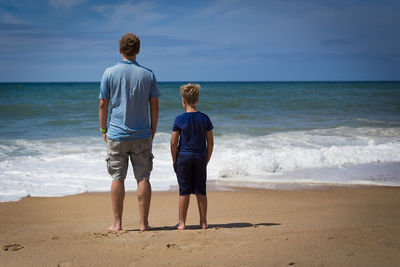 Rear view of friends on beach