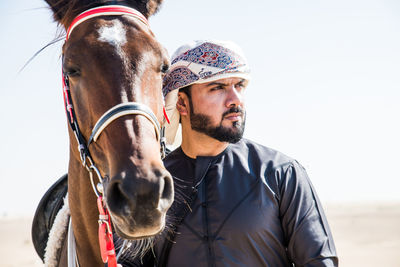 Man standing with horse in dessert