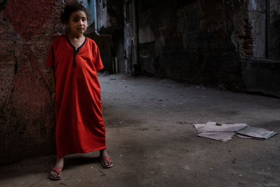 Portrait of boy standing against wall