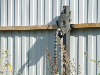 Close-up of metal fence against wall