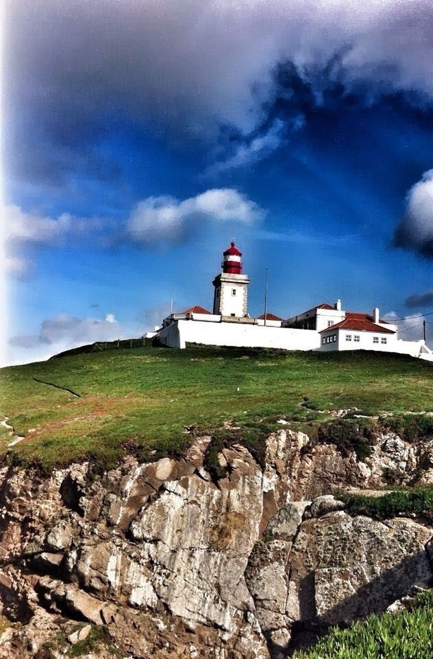 building exterior, architecture, built structure, lighthouse, sky, cloud - sky, guidance, grass, cloud, protection, direction, cloudy, safety, house, nature, security, day, tranquil scene, tranquility, landscape