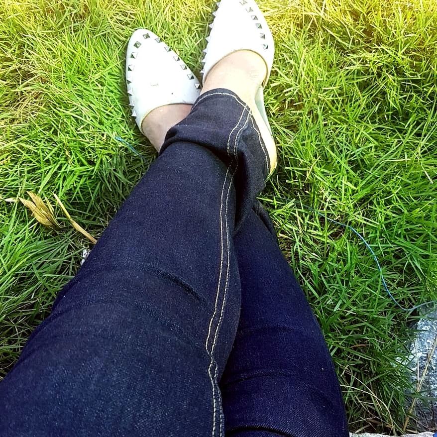 grass, low section, plant, human leg, real people, one person, personal perspective, field, land, human body part, body part, high angle view, green color, lifestyles, casual clothing, shoe, day, jeans, nature, outdoors, human foot, human limb