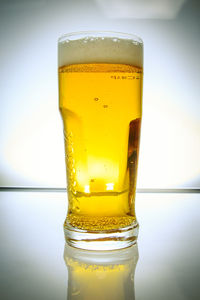 Close-up of beer glass on table