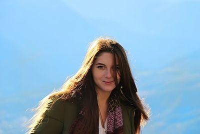 Portrait of beautiful woman against sky