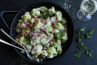 Stir-fried romanesco cauliflower with ham and parmesan.