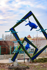 Traditional windmill in park against sky