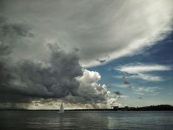 Scenic view of calm sea against cloudy sky