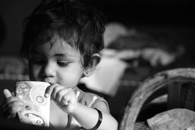 Close-up portrait of cute boy with toy