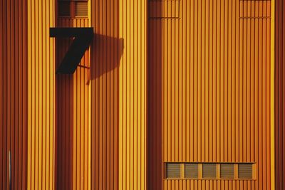 Low angle view of illuminated orange wall in building