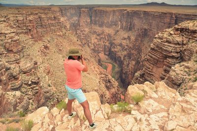 High angle view of man standing on cliff