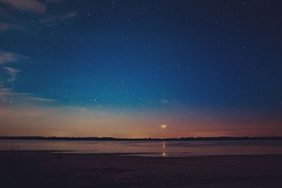 Scenic view of sea against sky at night