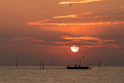 Scenic view of boat on sea against sky during sunset